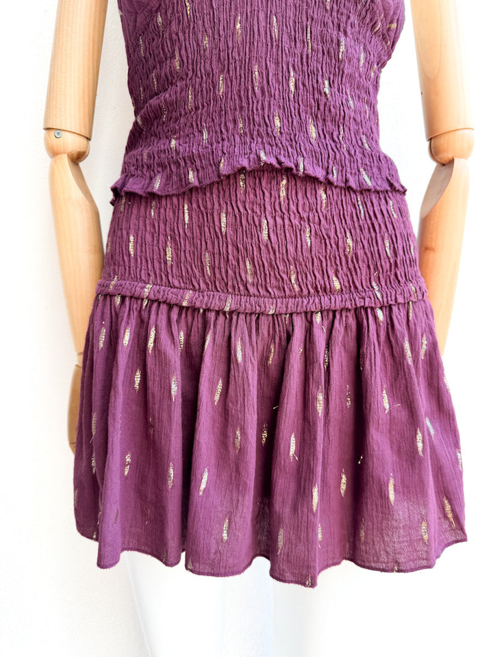 Conjunto halter de top smock y falda pantalón con detalles dorados
