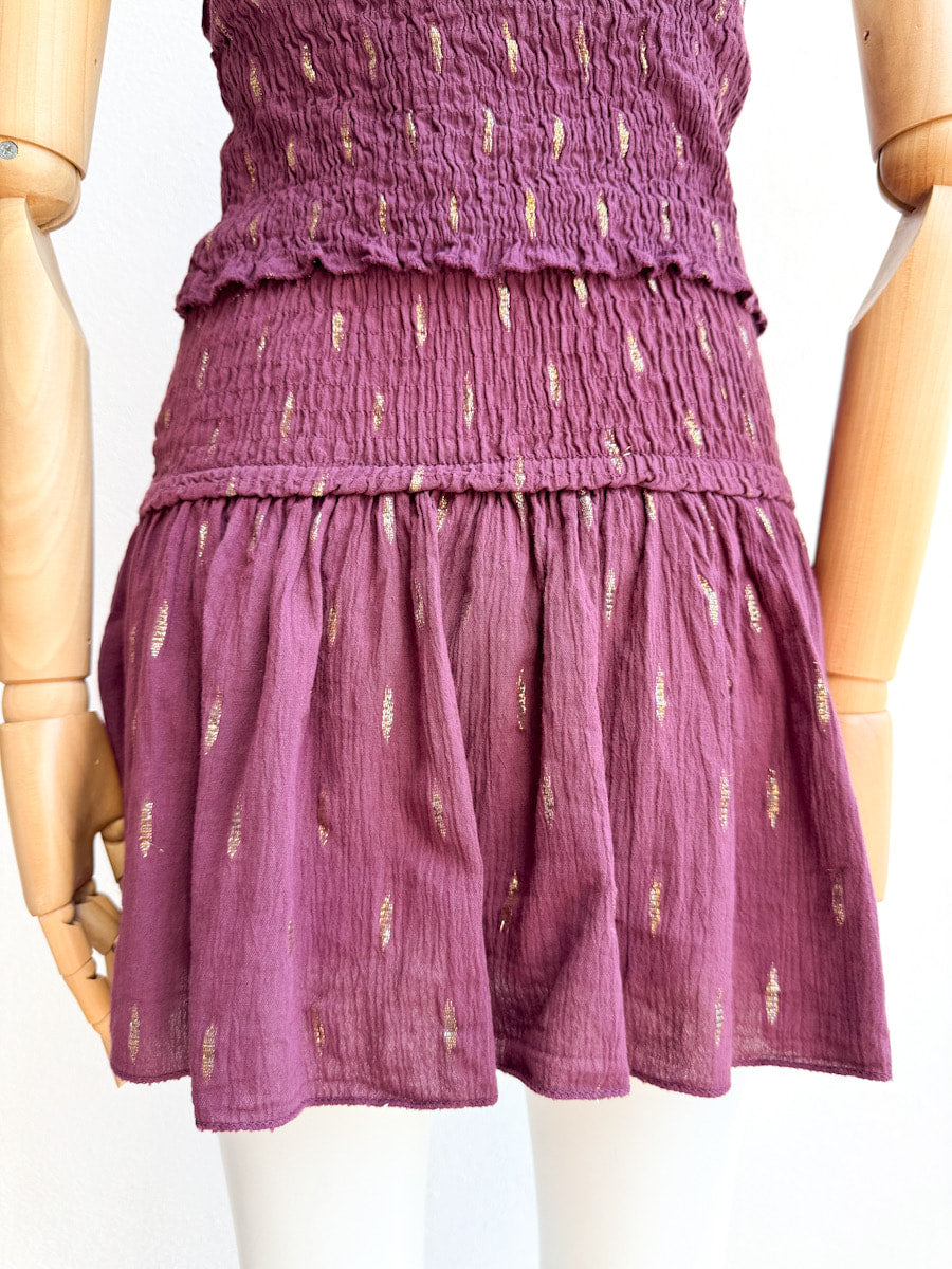 Conjunto halter de top smock y falda pantalón con detalles dorados